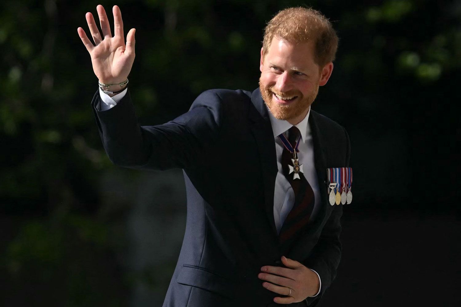 Britain's Prince Harry, Duke of Sussex waves as he arrives to attend a ceremony marking the 10th anniversary of the Invictus Games, at St Paul's Cathedral in central London, on May 8, 2024