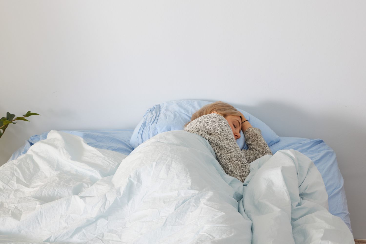 A person sleeping inside of the Riley Percale Duvet Cover