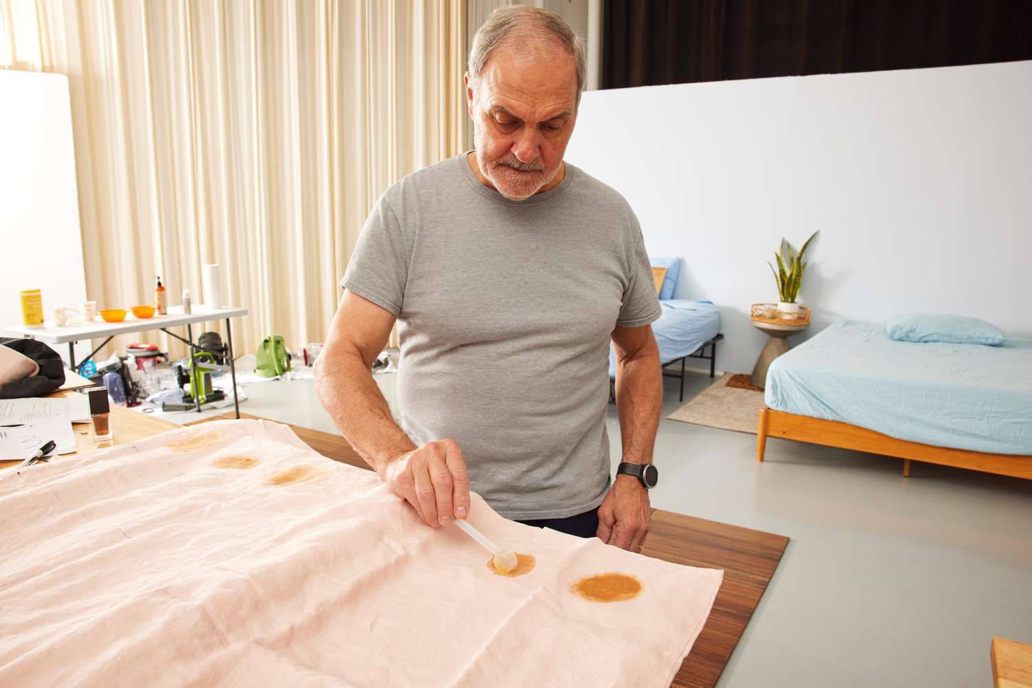 A person adding dark liquids with a spoon onto the Cultiver Linen Duvet Cover