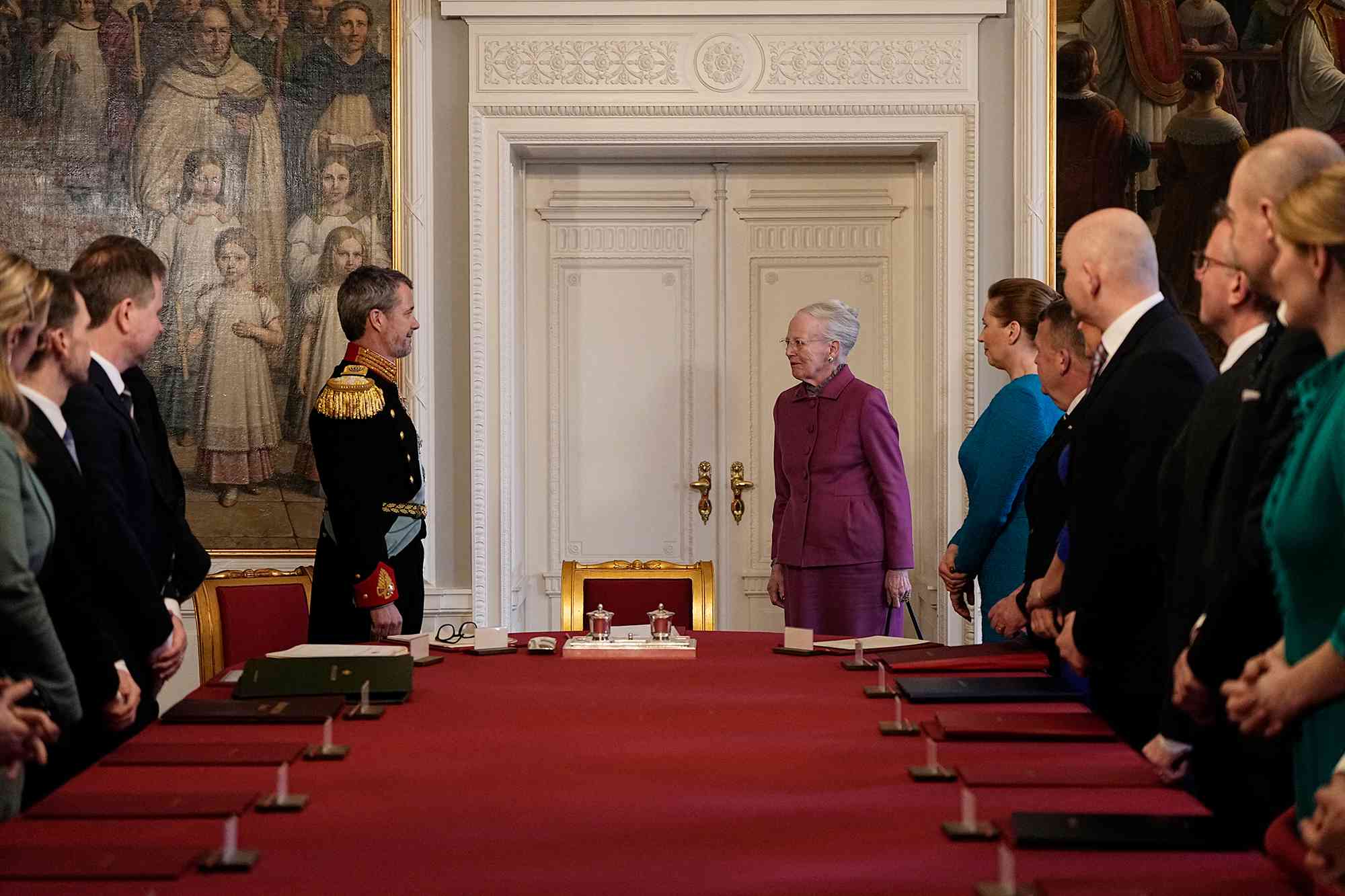 After signing the declaration of abdication Queen Margrethe II of Denmark (C-R) leaves the seat at the head of the table to her son King Frederik X of Denmark during the meeting of the Council of State at the Christiansborg Castle in Copenhagen