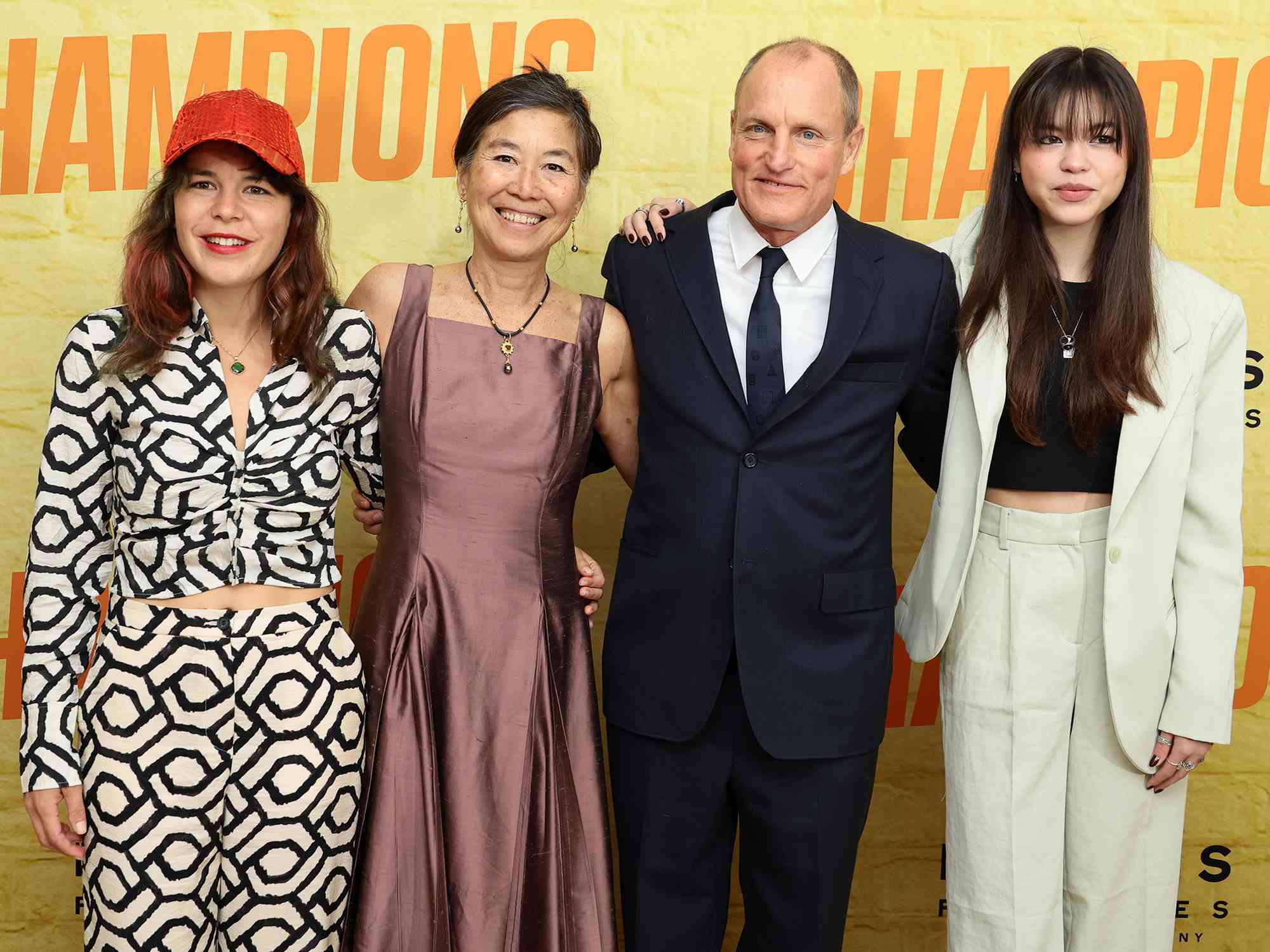 Laura Louie and Woody Harrelson attend the premiere of "Champions" at AMC Lincoln Square Theater on February 27, 2023 in New York City.