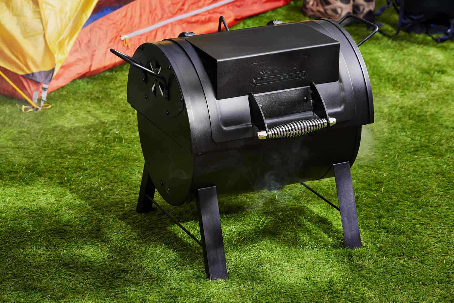 Dyna-Glo Portable Tabletop Charcoal Grill displayed on grass