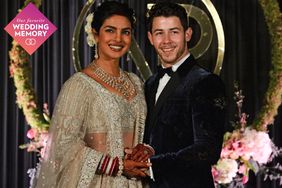 Indian Bollywood actress Priyanka Chopra (L) and US musician Nick Jonas, who were recently married, pose for a photograph during a reception in New Delhi on December 4, 2018.