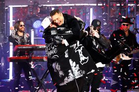 US rapper Jelly Roll hugs media personality and game show host, Ryan Seacrest, during the New Year's Eve celebration in Times Square on January 1, 2024, in New York City