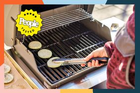 Hand using tongs to place onions on the Weber Spirit II E-210 2-Burner Liquid Propane Grill