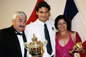 Roger Federer poses with his trophy and parents Lynettee and Robert at the Wimbledon Winners' Dinner at the Savoy Hotel on July 9, 2006 in London, England. 