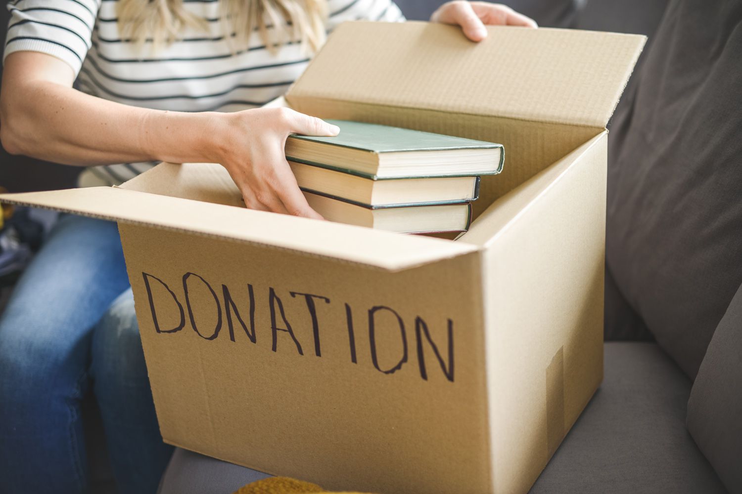 woman puts donations in a box