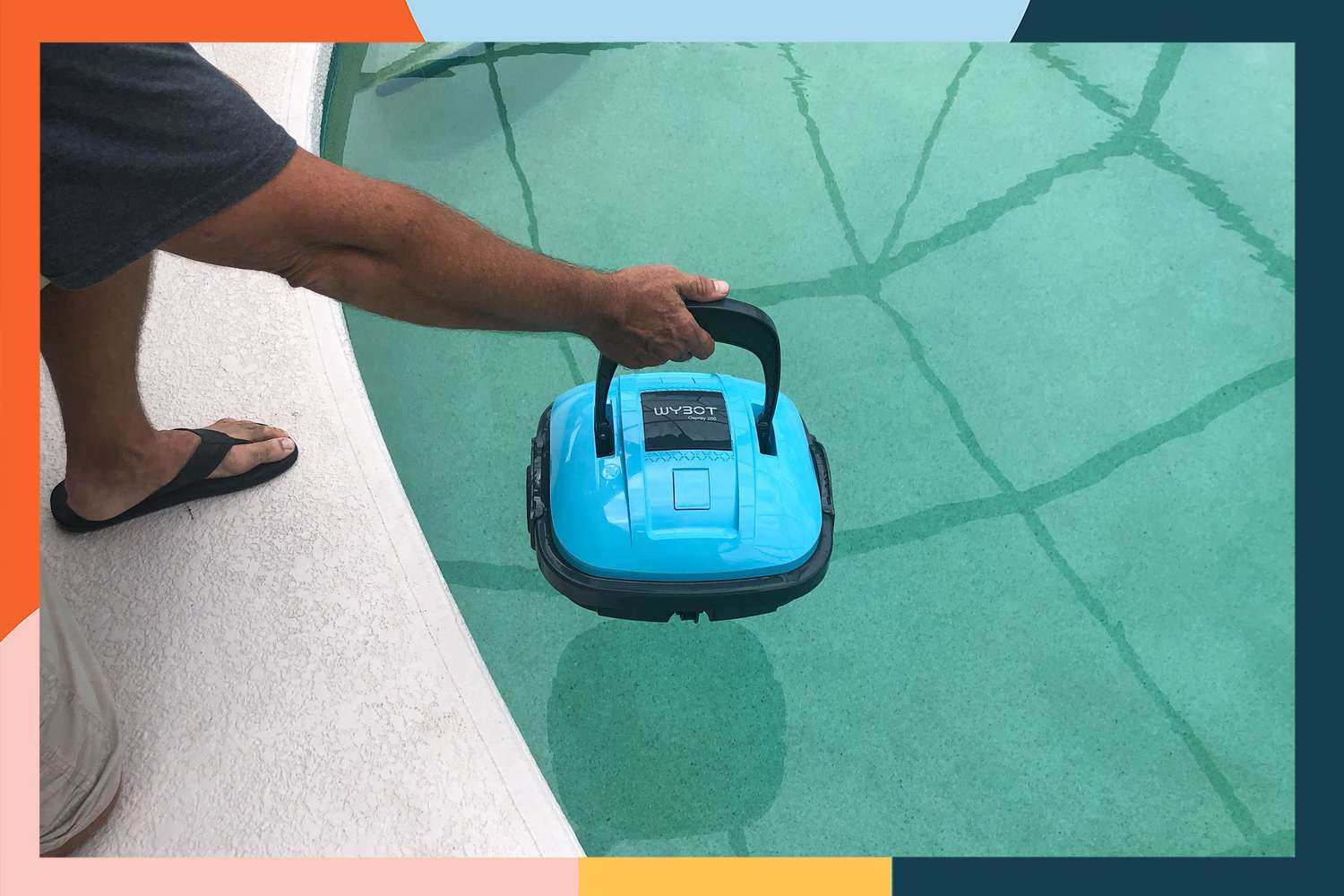 A person placing the Wybot Cordless Robotic Pool Cleaner into a pool