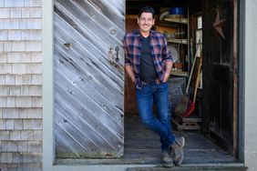 Jonathan Knight in front of the garden shed at his New England farmhouse, as seen on Farmhouse Fixer.