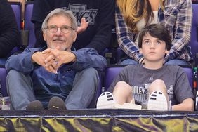 Harrison Ford (L) and Liam Flockhart attend a hockey game between the Carolina Hurricanes and the Los Angeles Kings at Staples Center on March 1, 2014 in Los Angeles, California