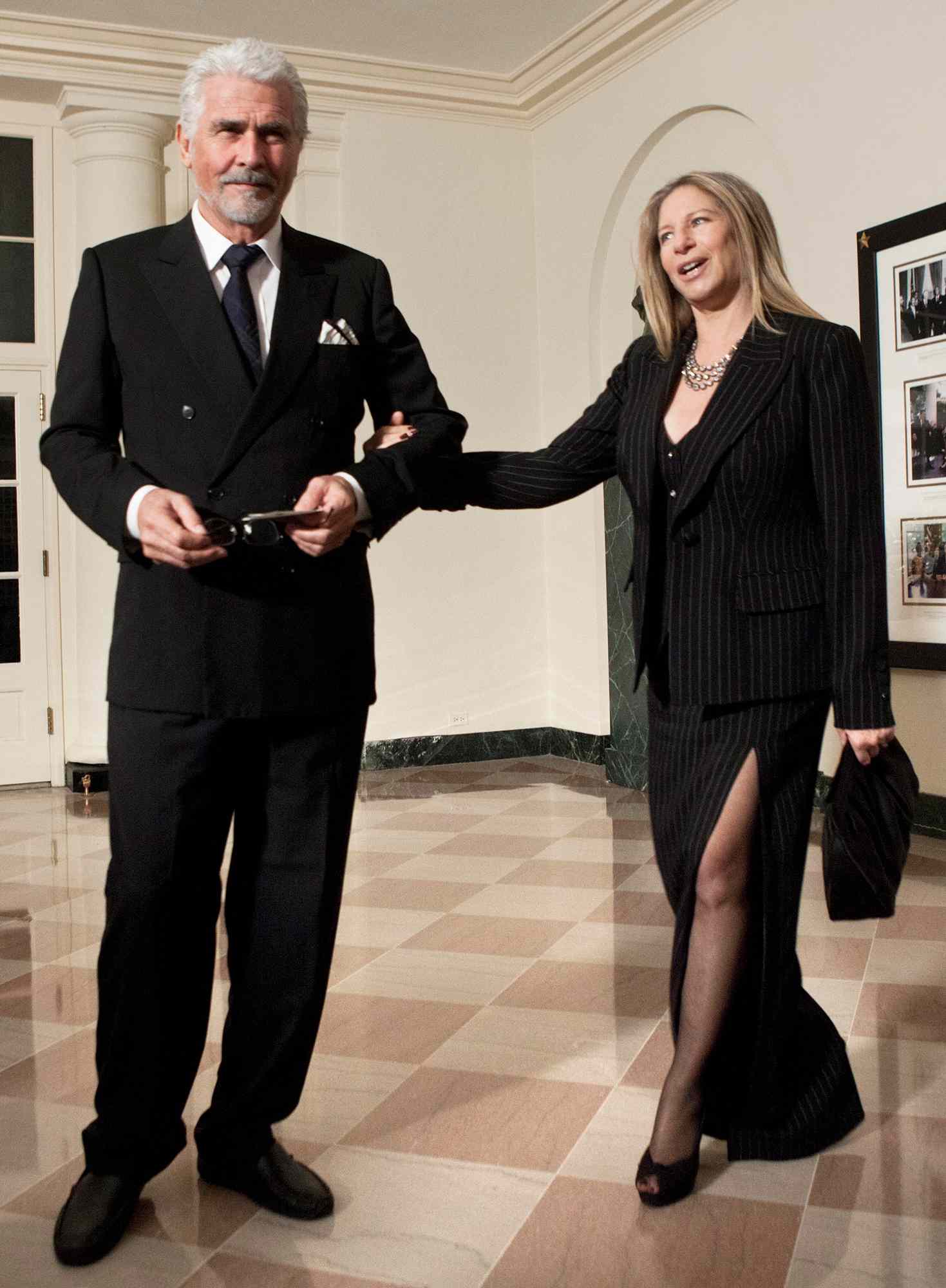 Barbra Streisand (R) pulls on her husband actor James Brolin's arm while arriving at the White House for a state dinner 19, 2011 in Washington, DC. President Barack Obama and first lady Michelle Obama are hosting resident Hu Jintao for a state dinner during his visit to the United States