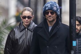 Gigi Hadid and boyfriend Bradley Cooper are seen holding hands as they take a romantic stroll around London on Thursday afternoon