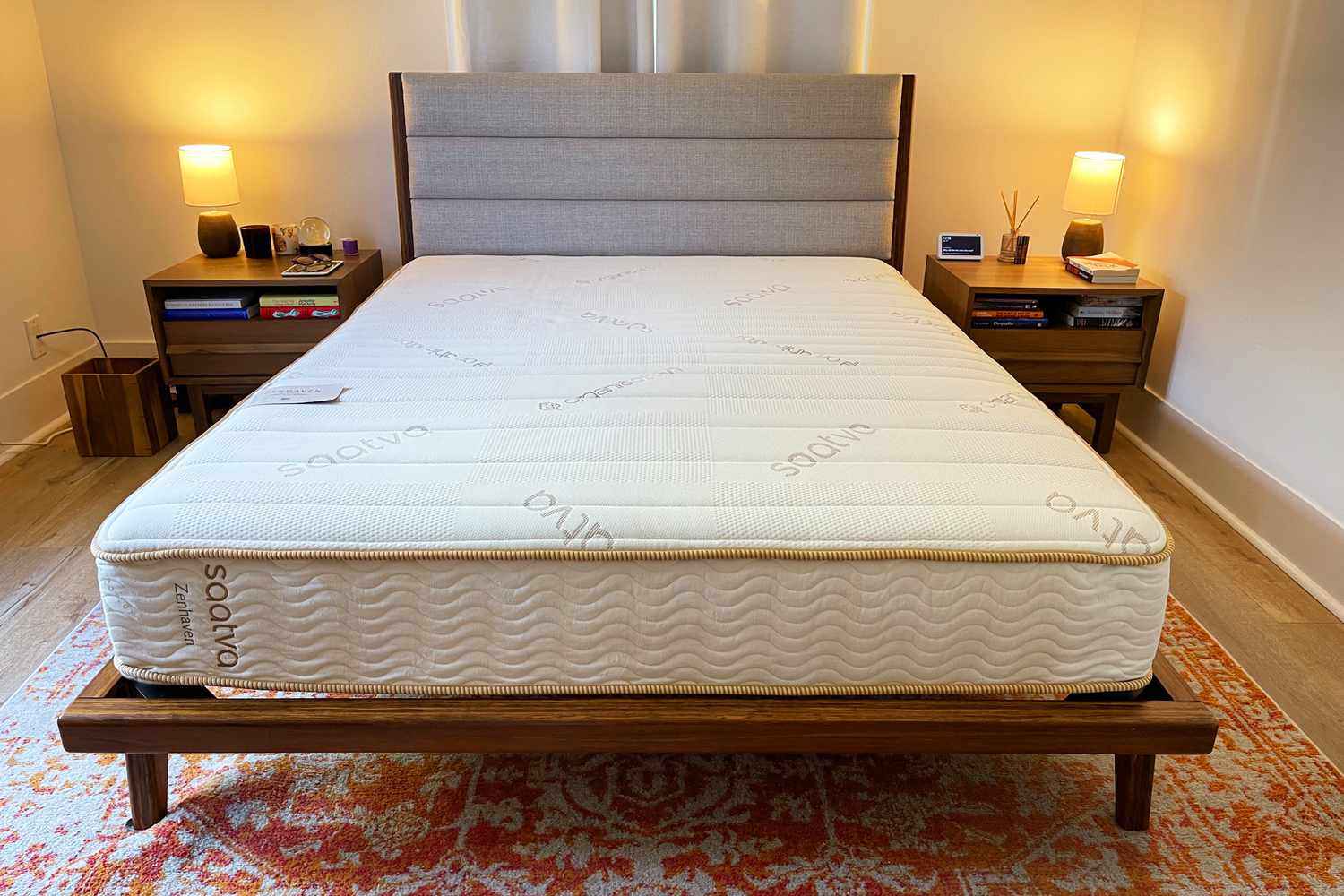 Saatva Zenhaven Natural Latex Mattress on bedframe while displayed on rug with nearby nightstands