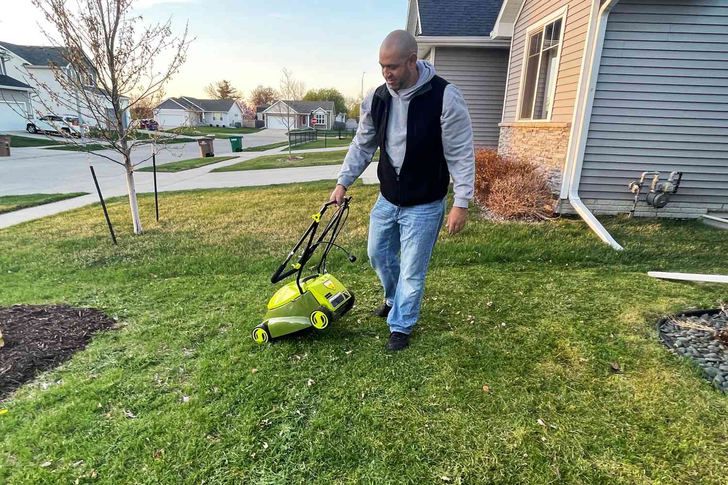 Person pulling the Sun Joe MJ401E-P2 Electric Lawn Mower across lawn