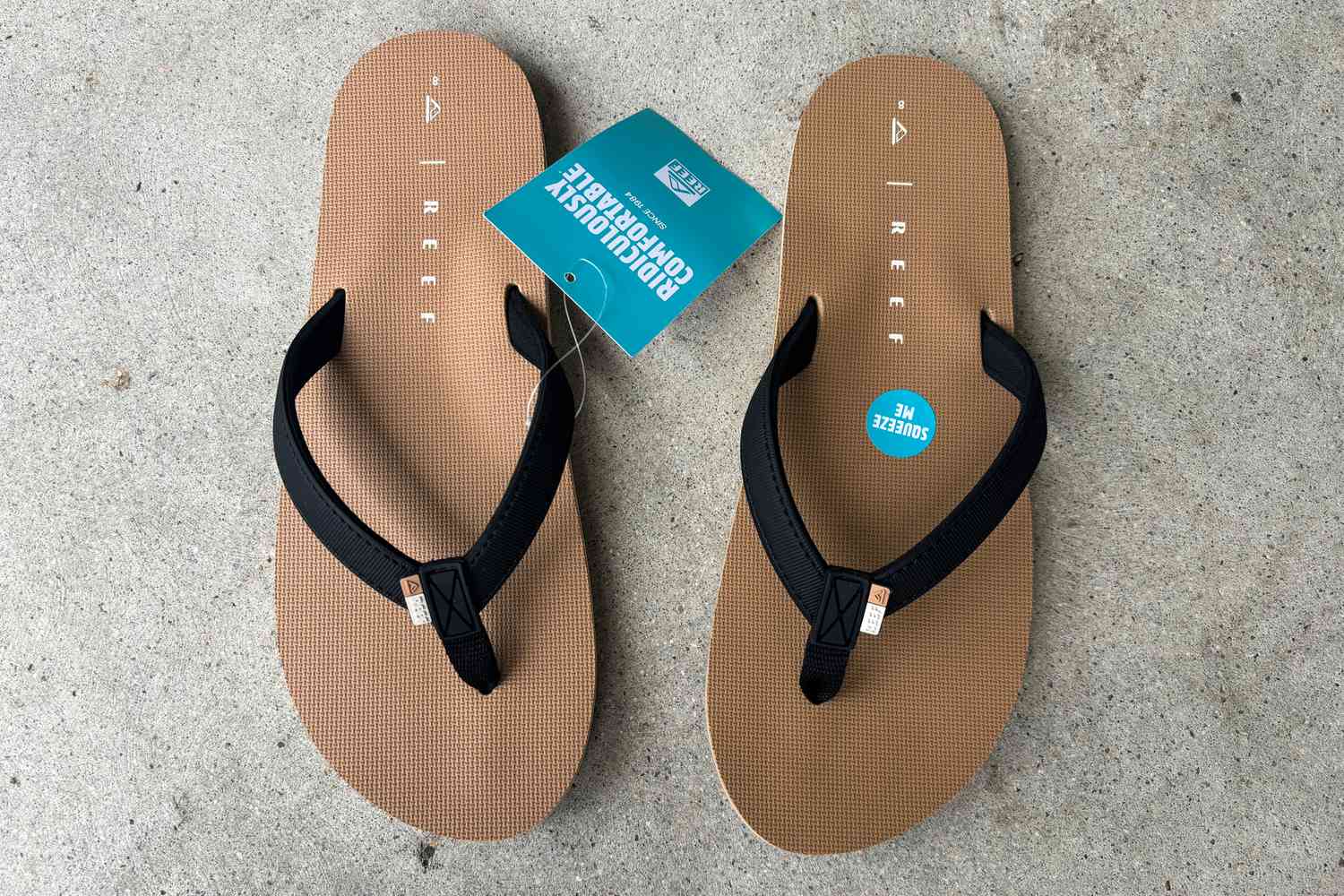 Reef Solana Flip Flops on concrete with tag on one flip flop