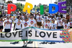 People hold banners and balloons as they take part in the Denver Pride Parade on June 16, 2019 in Denver, Colorado. The annual parade begins in Cheesman Park, moves along Colfax ave and ends in front of the Colorado State capitol. This year's PrideFest was a two-day festival that featured the parade, live entertainment on three stages in Civic Center park, and more than 200 exhibitors. Since 1990, Denver PrideFest has grown into the largest celebration of LGBTQ pride in the area. This year's festival marked the 50th anniversary of the Stonewall riots in 1969 in New York City. More than 250 groups marched in this year's parade, a record for the event.