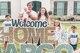 Buller Family poses with baby Margo with Welcome Home Margo sign on their lawn