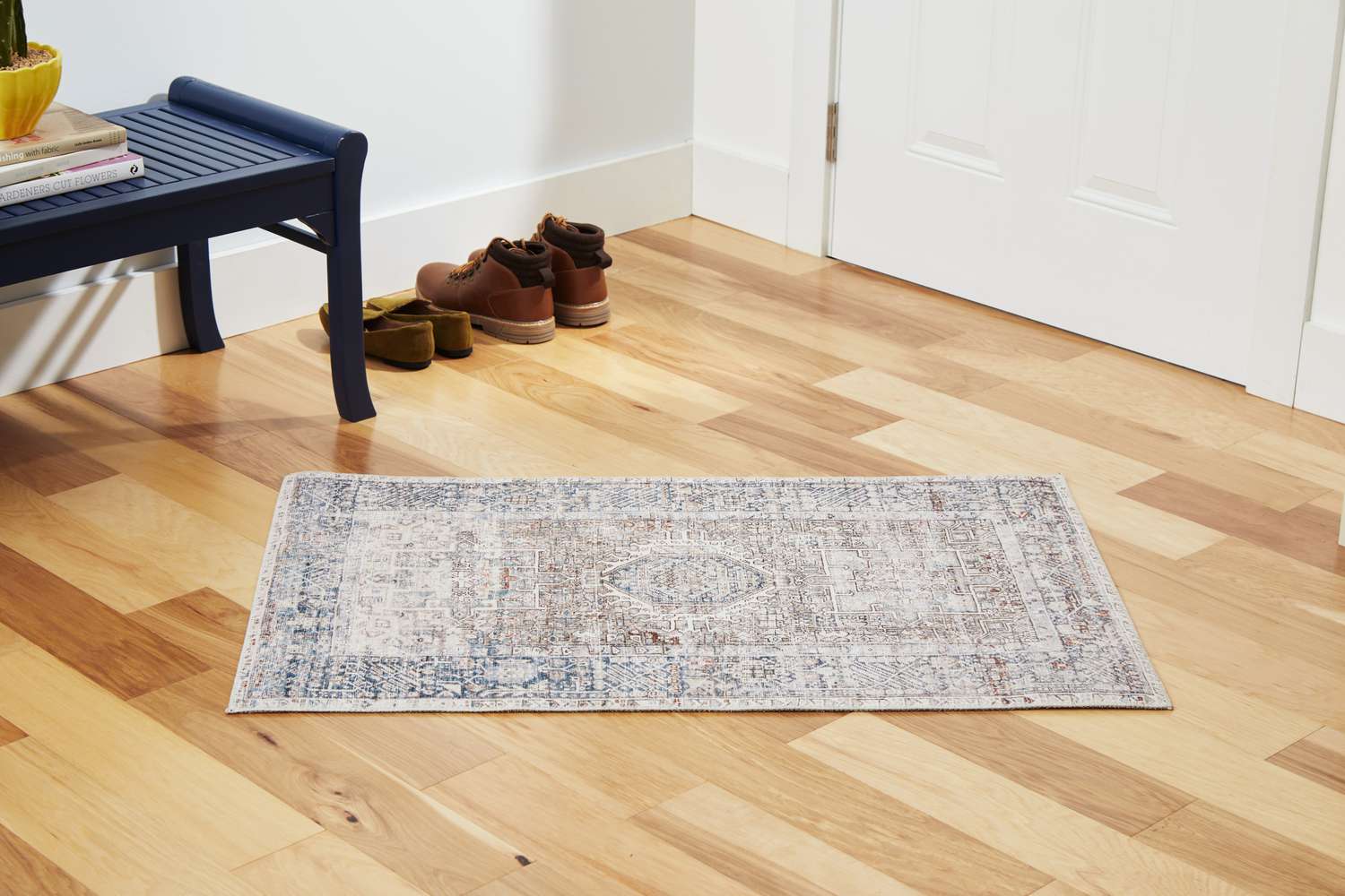 The Chris Loves Julia x Loloi Jules Oriental Area Rug on a wooden floor