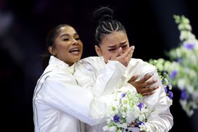 : Jordan Chiles and Suni Lee react after being selected for the 2024 U.S. Olympic Women's Gymnastics Team on Day Four of the 2024 U.S. Olympic Team Gymnastics Trials at Target Center on June 30, 2024