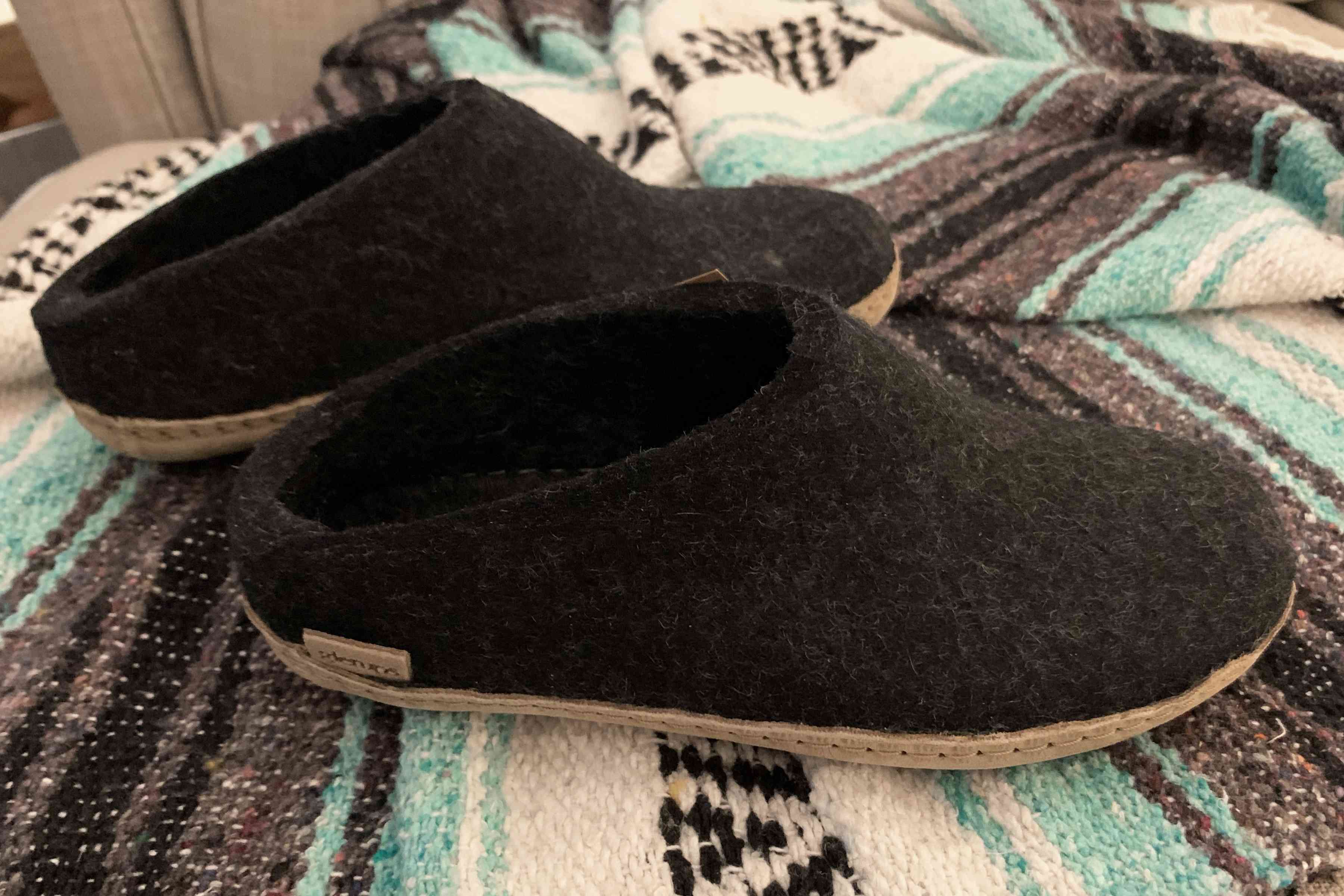 Glerups Wool Slip-On Leather Slippers sit on blanket