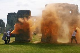 An image grab from a video released by the Just Stop Oil climate campaign group shows activists spraying an orange substance at Stonehenge in Wiltshire, southwest England, on June 19, 2024.