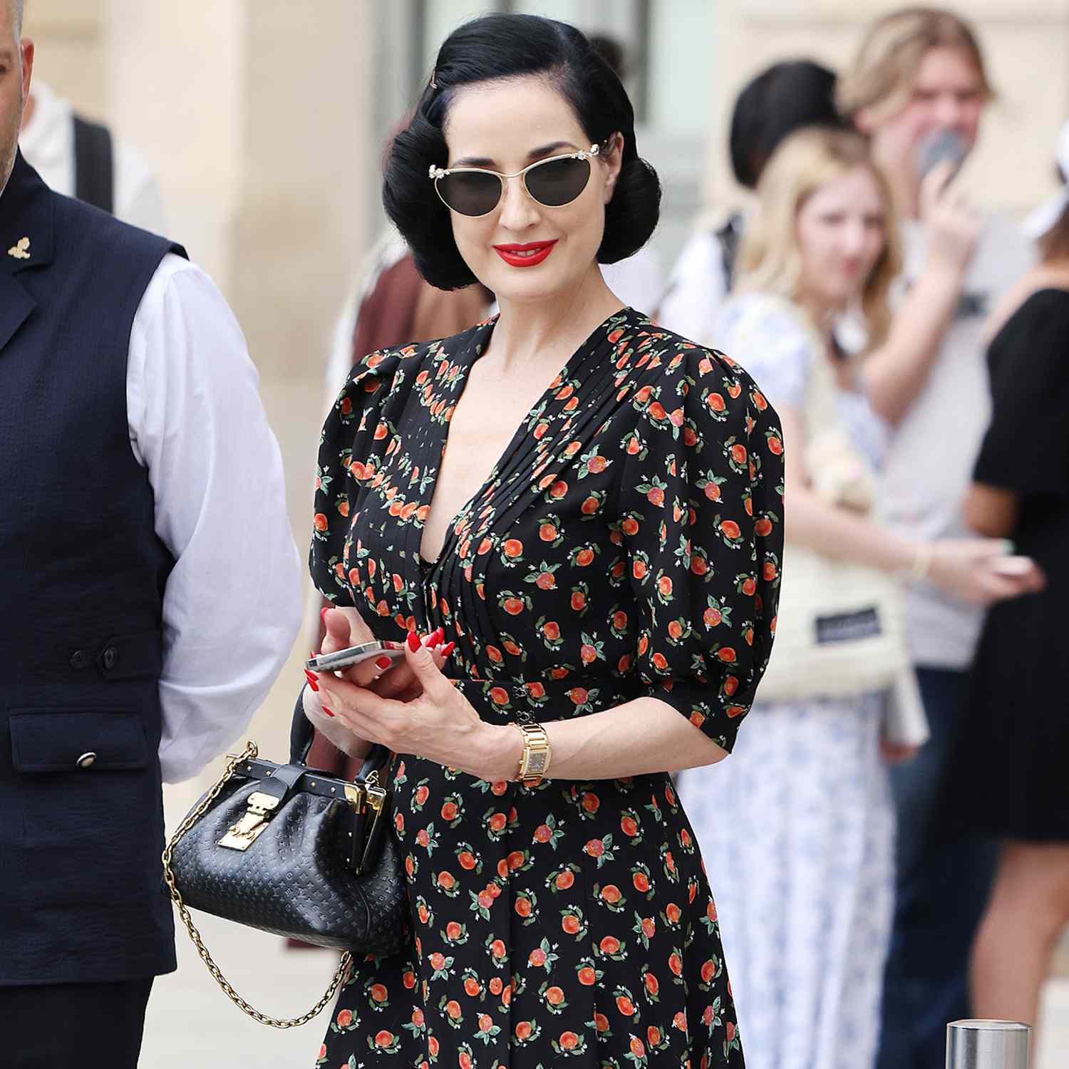 Dita Von Teese is pictured leaving her hotel in Paris this afternoon. Data was seen carrying a Louis Vuitton bag, floral dress and black sunglasses.
