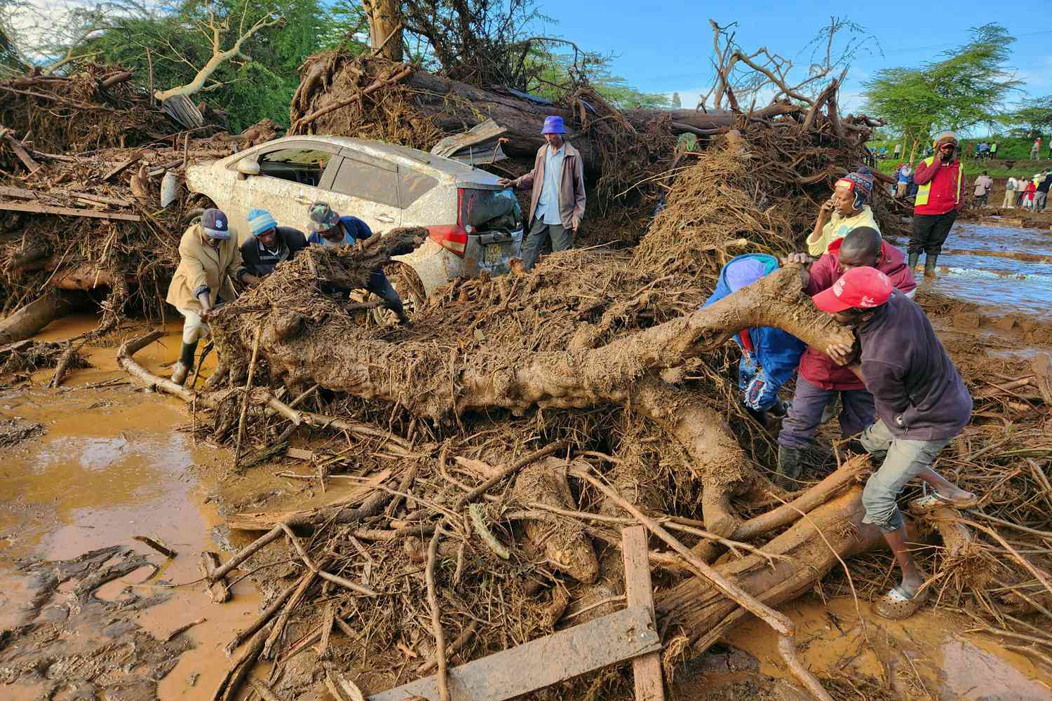 People try to clear the area after a dam burst, in Kamuchiri Village Mai Mahiu, Nakuru County, Kenya, Monday, April 29, 2024. Police in Kenya say at least 40 people have died after a dam collapsed in the country's west. 
