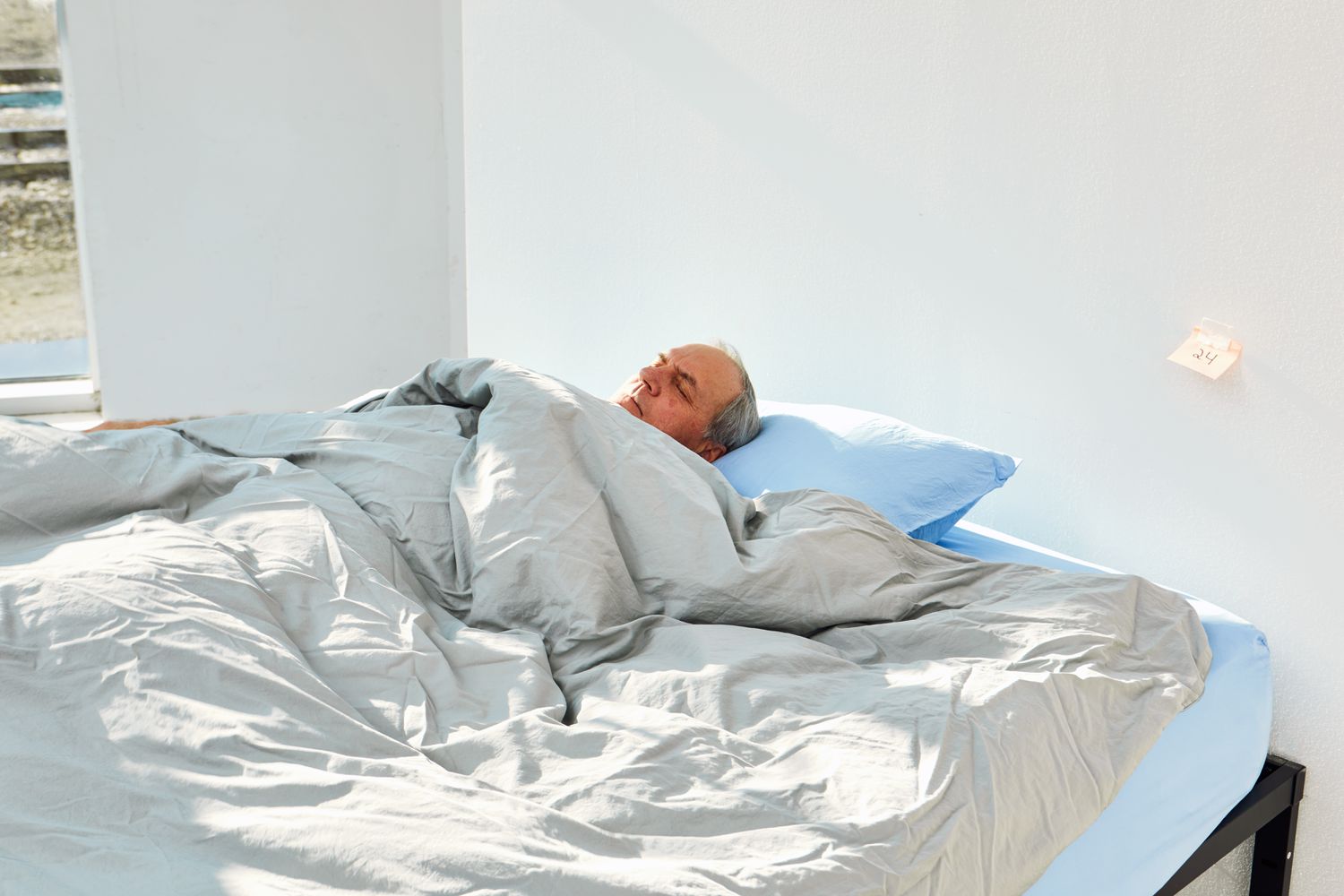 Person sleeping in a bed made with the Slumber Cloud Essential Duvet Cover