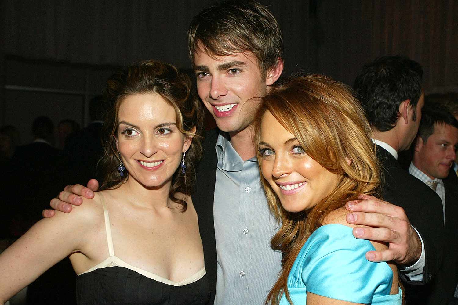 Actress Tina Fey (L) poses with fellow cast members Jonathan Bennett and Lindsay Lohan at the after-party for Paramount's "Mean Girls" at the Cinerama Dome Theater on April 19, 2004 in Los Angeles, California. 