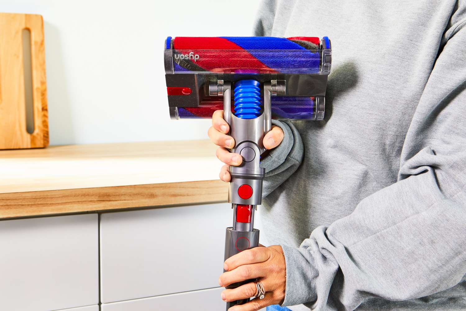 Hands assembling the Dyson Omni-Glide Cordless Vacuum