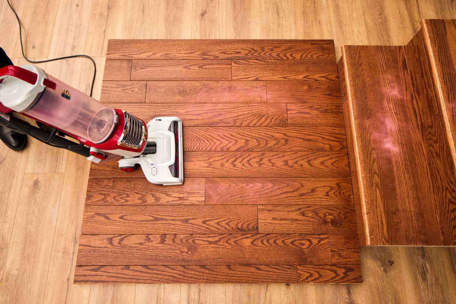 A person uses the Kenmore Allergen Seal Bagless Upright Vacuum to clean a wooden floor