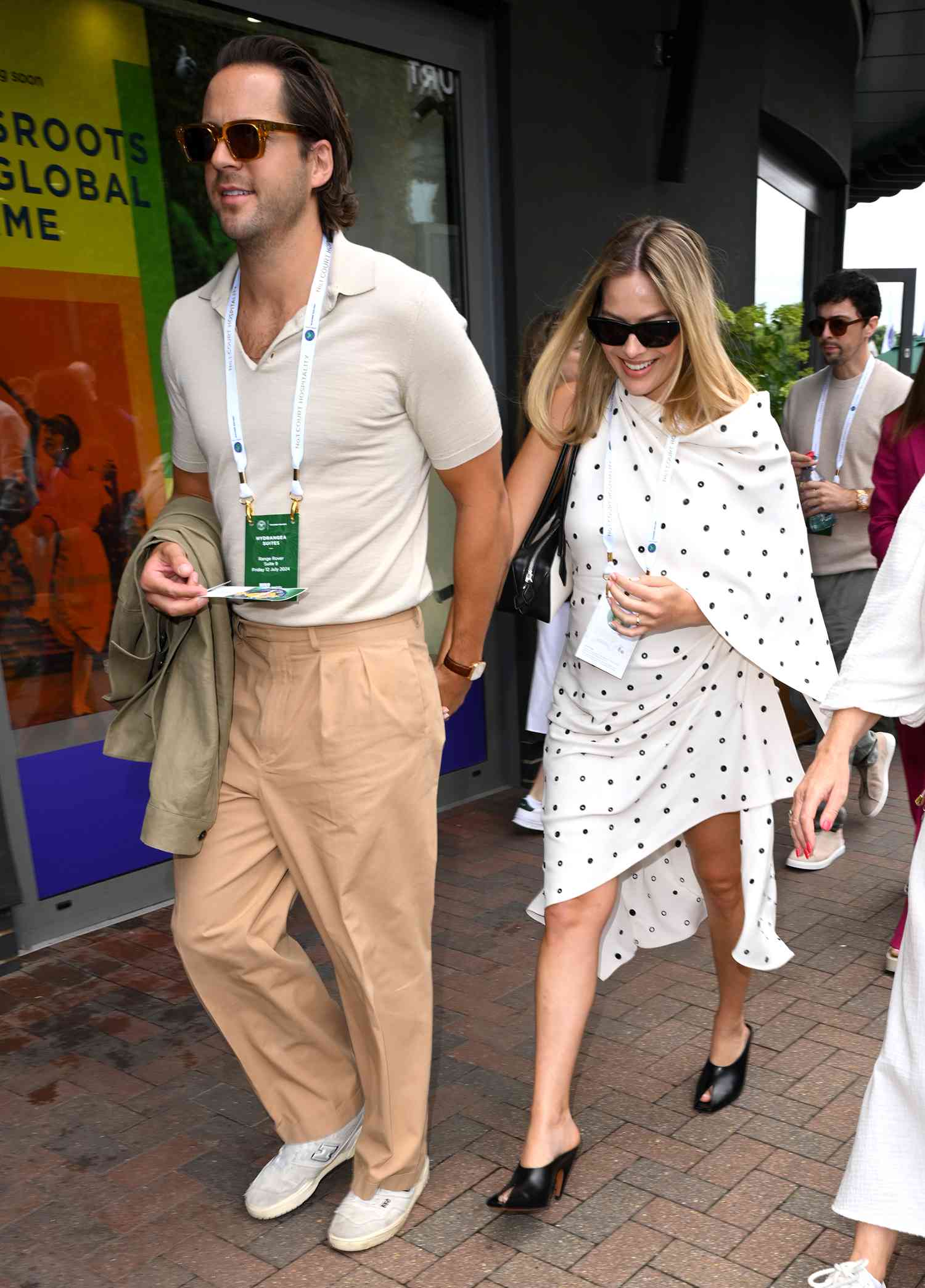 Tom Ackerley and Margot Robbie attend day twelve of the Wimbledon Tennis Championships at the All England Lawn Tennis and Croquet Club 