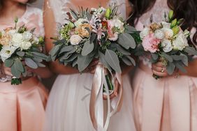 Bridesmaids and bride holding wedding bouquets.