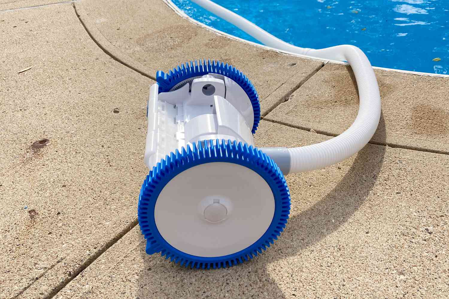 Hayward The PoolCleaner 2-Wheel Suction Cleaner displayed on cement at edge of pool