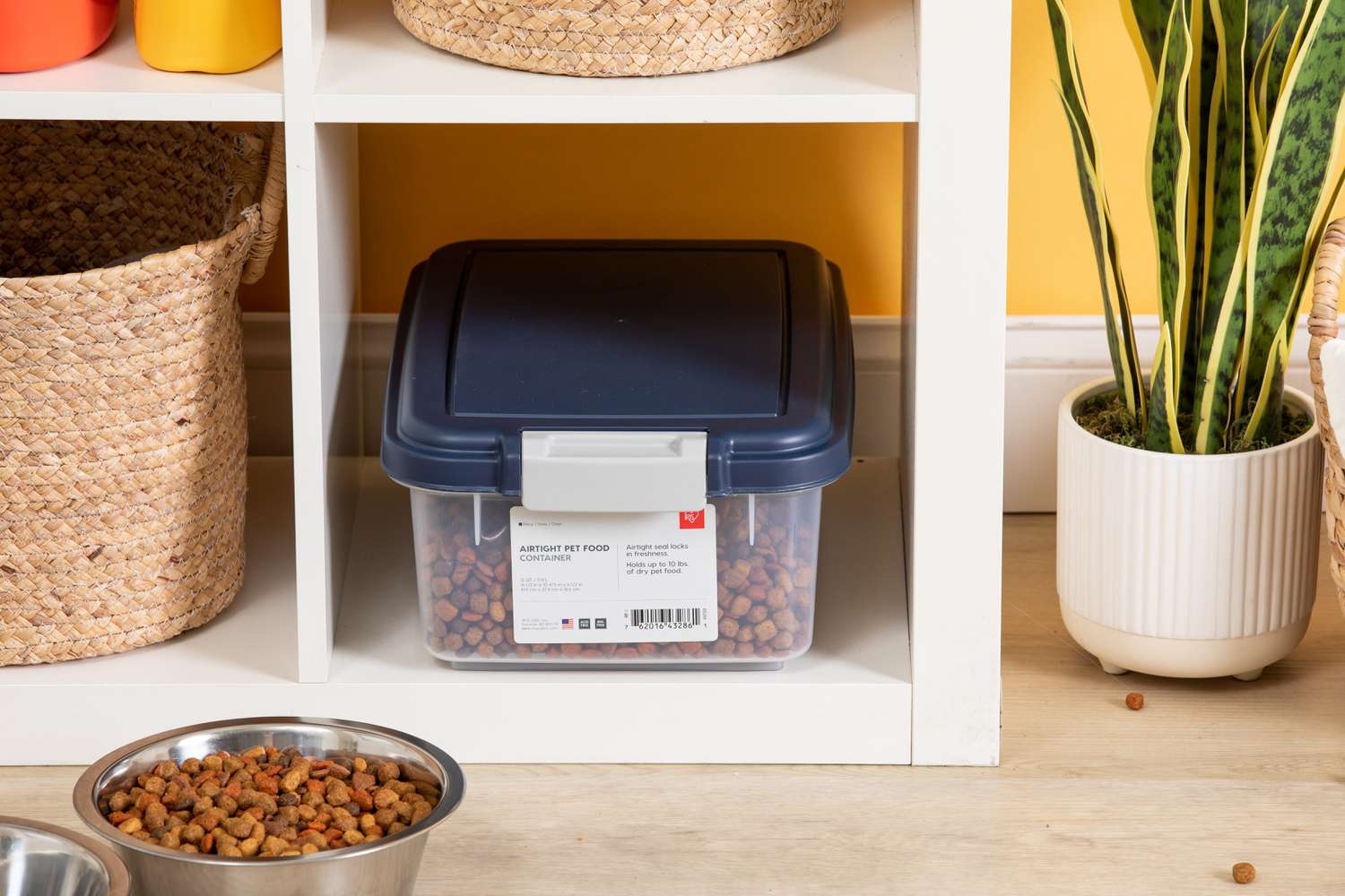 The upper component of IRIS Airtight Food Storage Container & Scoop Combo full of dog food in a cubbyhole