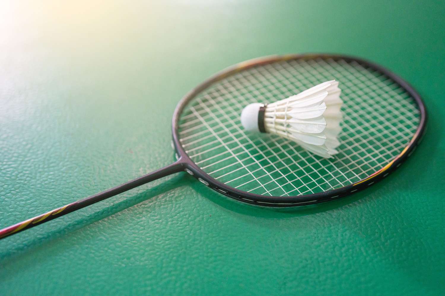 Close up shuttlecocks on racket bad mintons at badminton courts with players competing