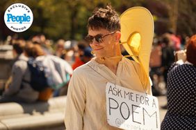 "Park Poet" Peter Chinman smiles as he waits for passersby to ask for poems at Washington Square Park in Manhattan on Sunday, April 14, 2024.