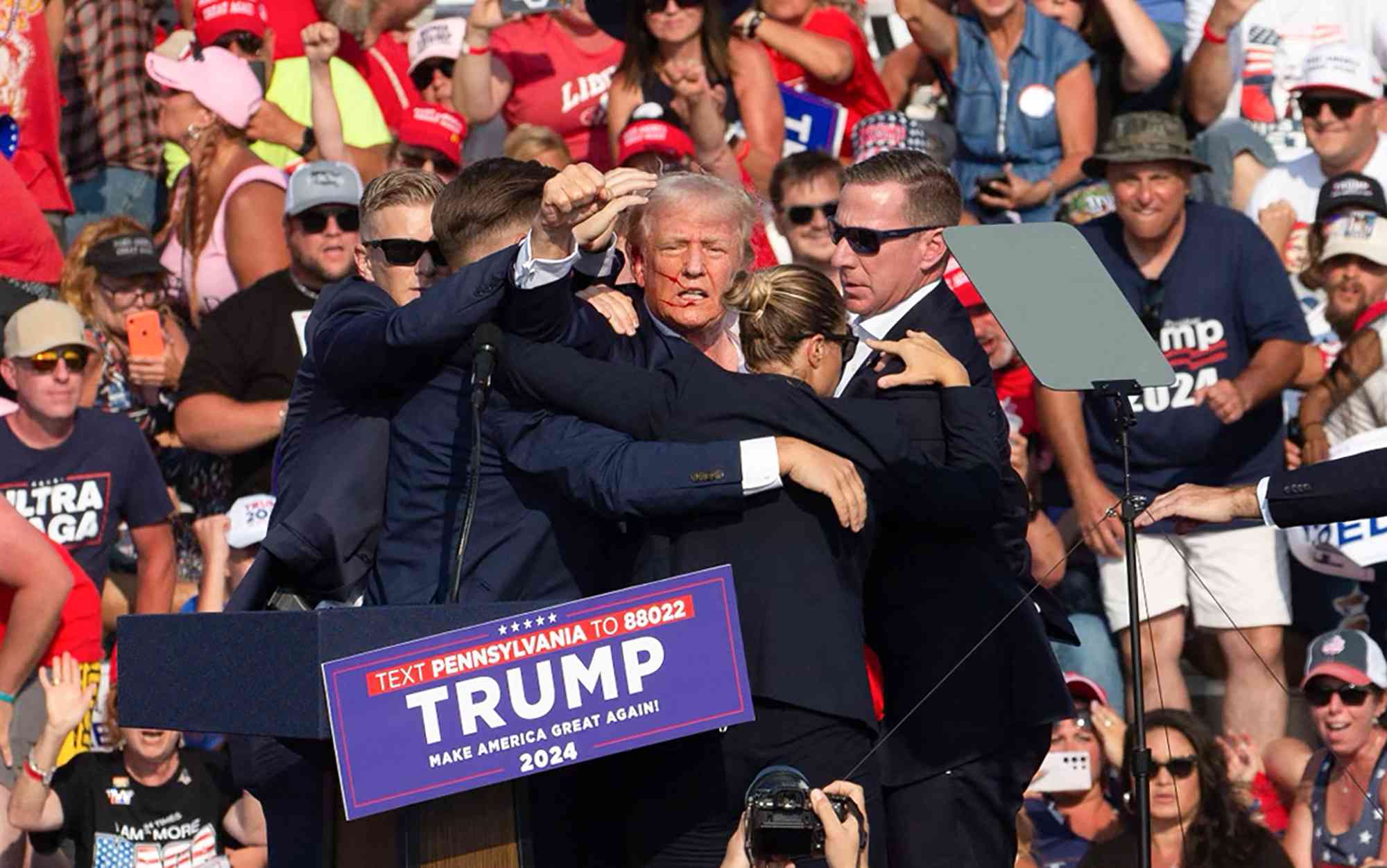 Republican candidate Donald Trump is seen with what appears to be blood on his face surrounded by secret service agents as he is taken off the stage at a campaign event at Butler Farm Show Inc. in Butler, Pennsylvania, July 13, 2024. 