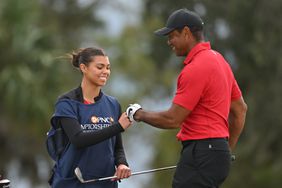 Tiger Woods and Sam Woods give knuckles on the 14th hole during the final round of the PNC Championship at Ritz-Carlton Golf Club on December 17, 2023 in Orlando, Florida