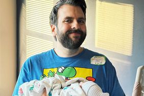 David Allen poses with newborn baby