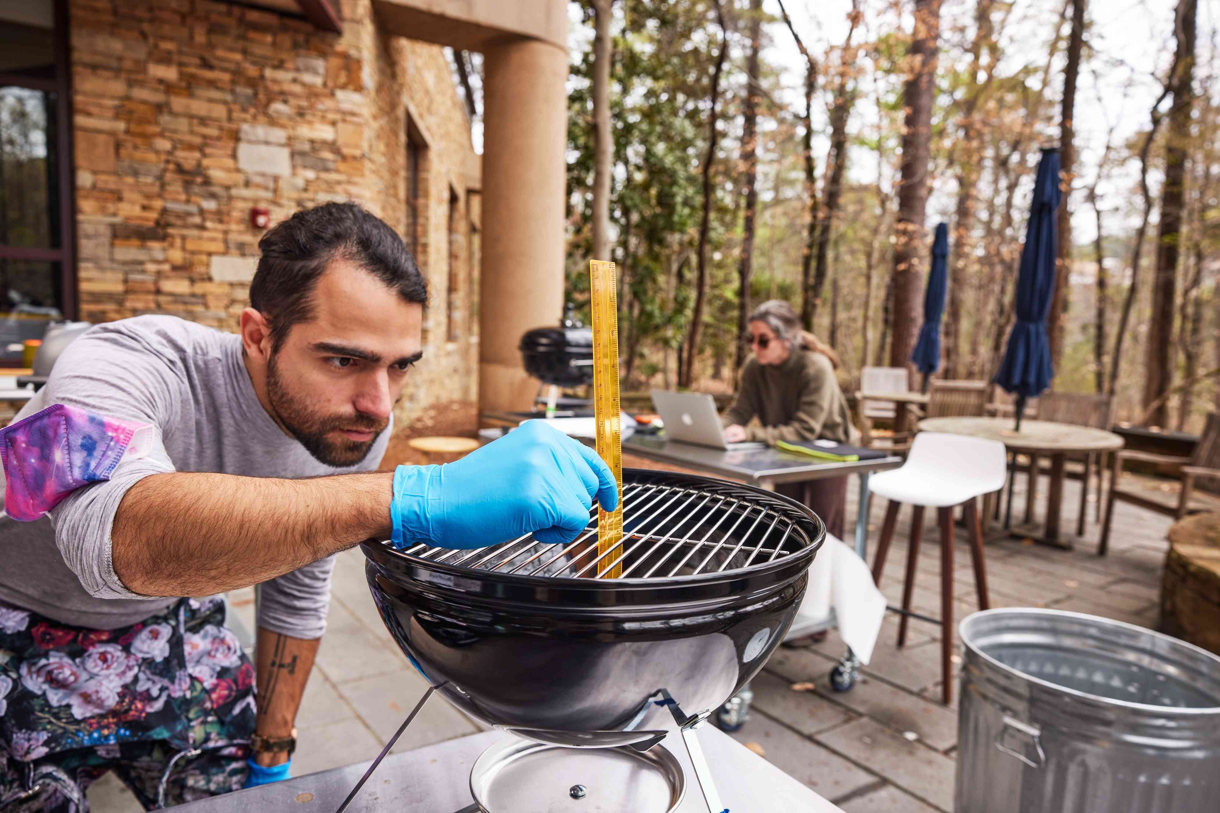 A man testing out a charcoal grill