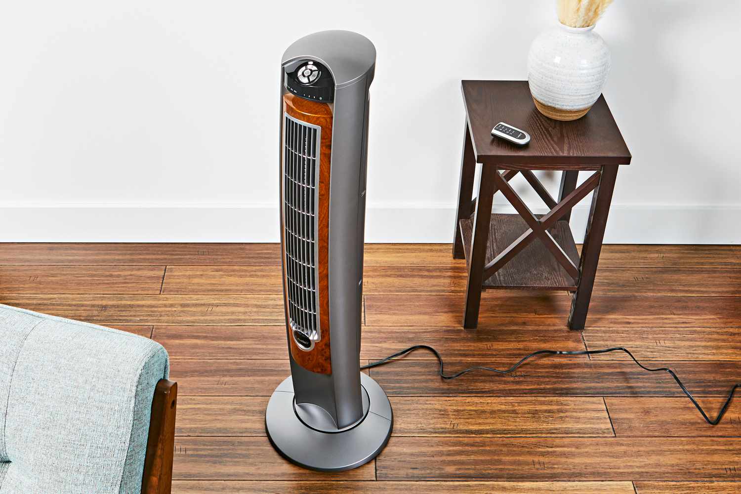 Lasko 42" Oscillating Tower Fan near a side table and chair