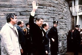 This photo taken by presidential photographer Mike Evens on March 30, 1981 shows President Ronald Reagan waving to the crowd just before the assassination attempt on him, after a conference outside the Hilton Hotel in Washington, D.C.