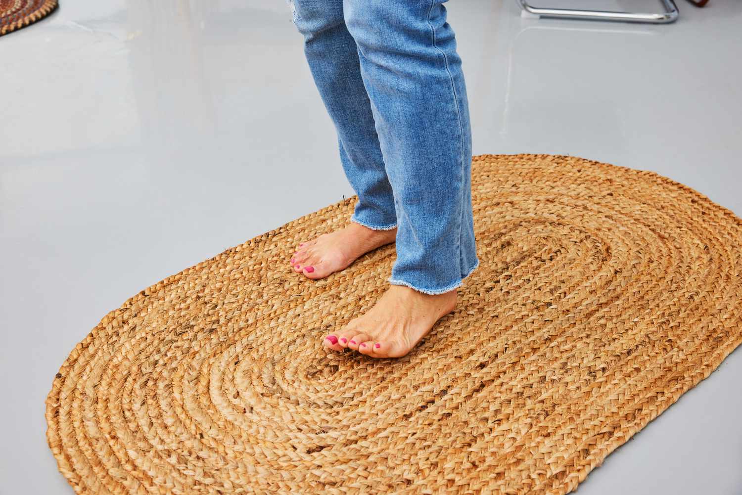 A person walks on the nuLOOM Rigo Hand Woven Jute Area Rug barefoot