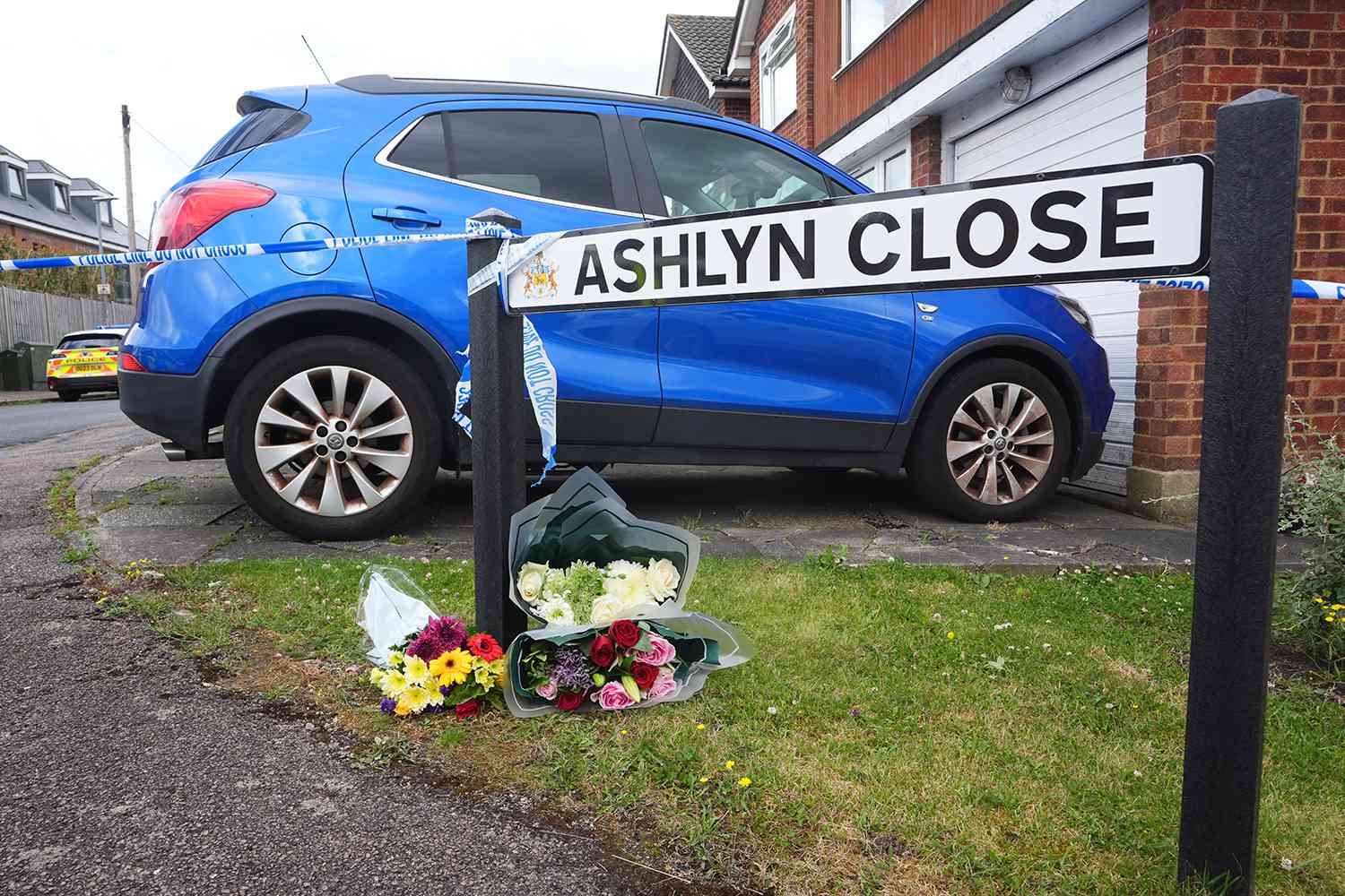 Floral tributes left near to the scene in Ashlyn Close, Bushey, Hertfordshire, where the wife and two daughters of a BBC sports commentator have been killed in a crossbow attack at their home. 