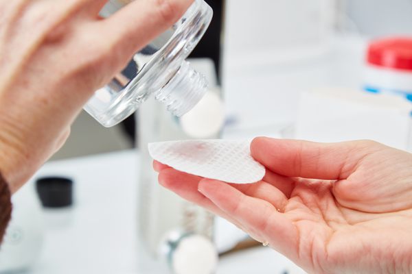 Person applying Freck Beauty Cactus Water Cleansing Lactic Acid Toner to a cotton pad 