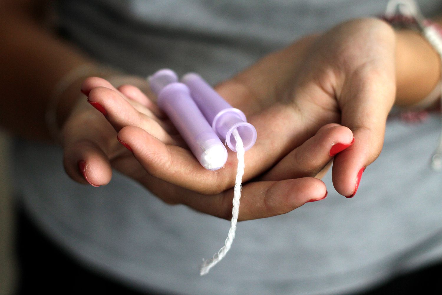 Stock image of woman holding tampons