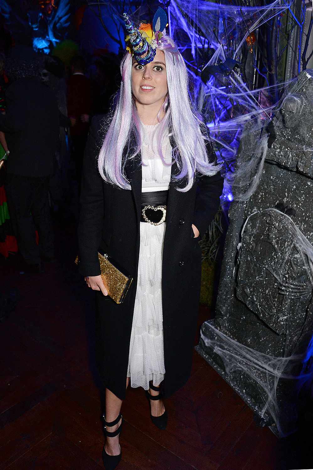 Princess Beatrice wearing a purple wig and whimsical unicorn horn on Halloween in 2018.