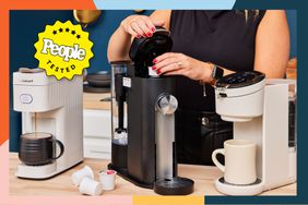 three single cup coffee makers sit on a counter while a person puts a pod into one