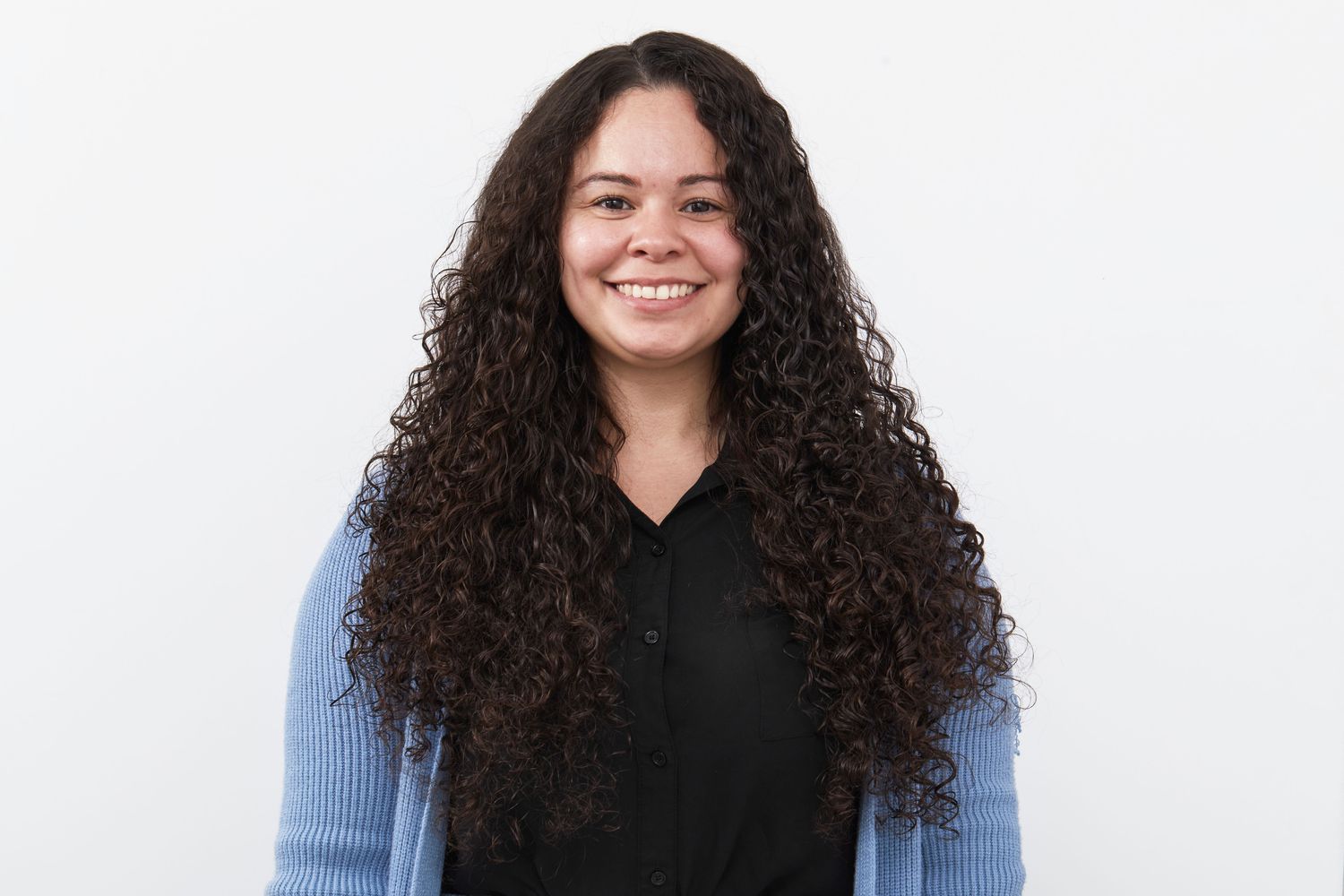 A person with curly hair after using the PATTERN Blow Dryer.